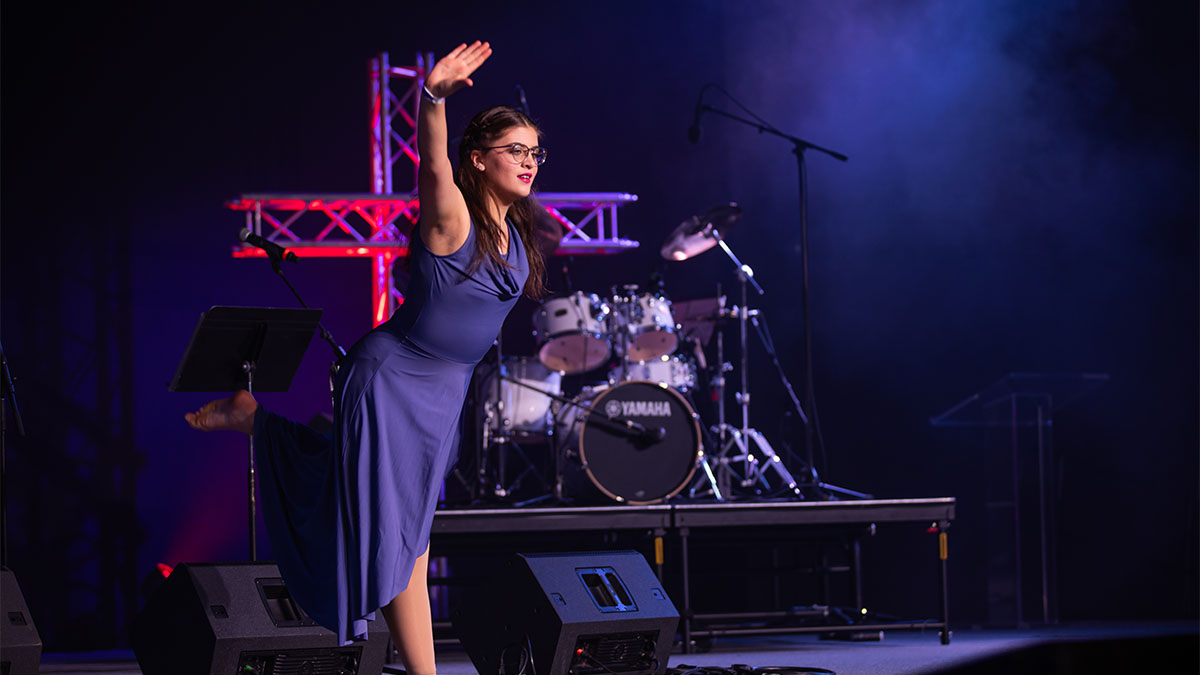 A student sharing Creative Arts on stage through dance