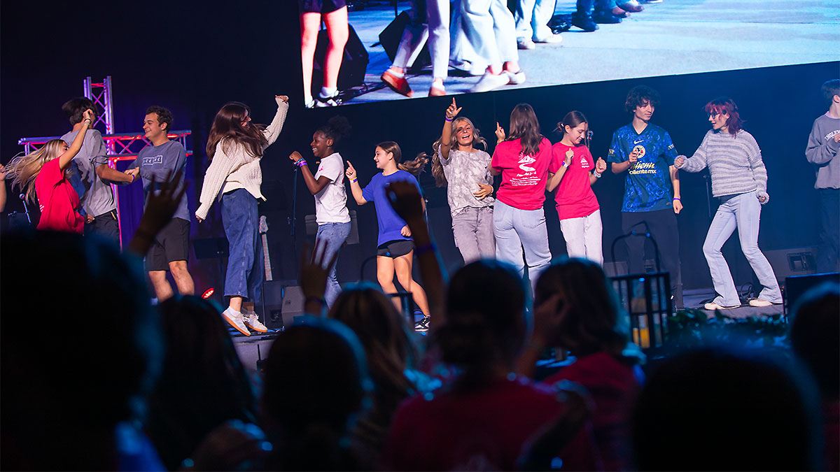 Students on stage dancing around